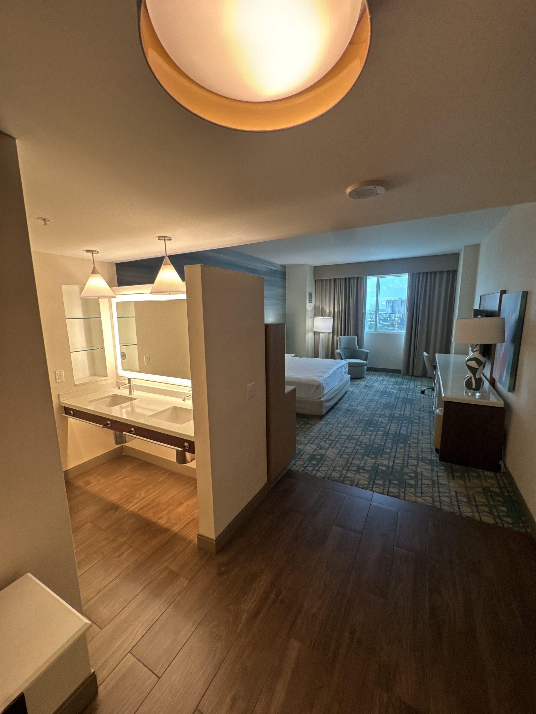 Finished hotel suite after a turnover clean — bed made, vanity spotless
