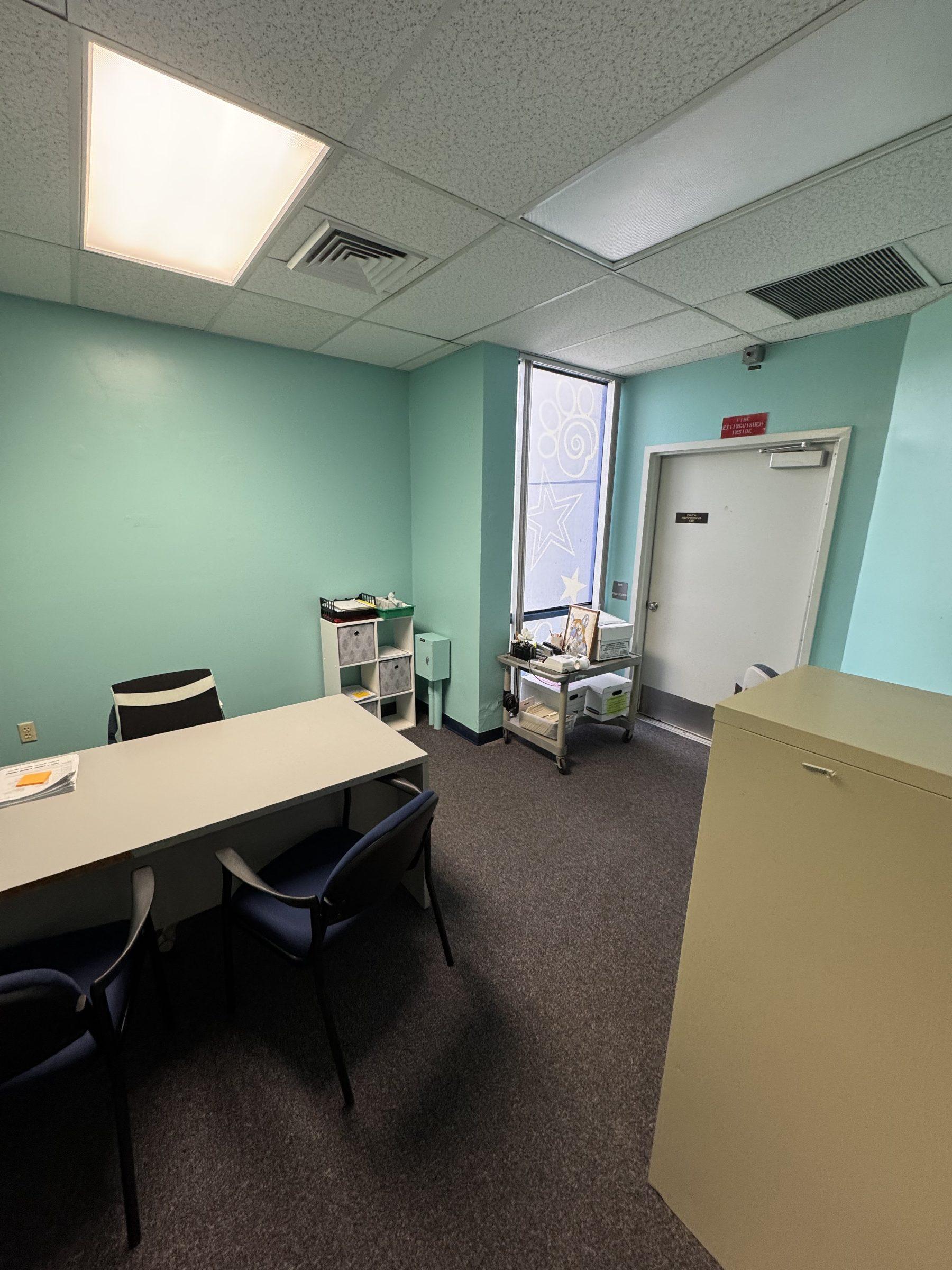 Office cleaned and reset after a full clear-out — clear desks, tidy shelves, vacuumed carpet