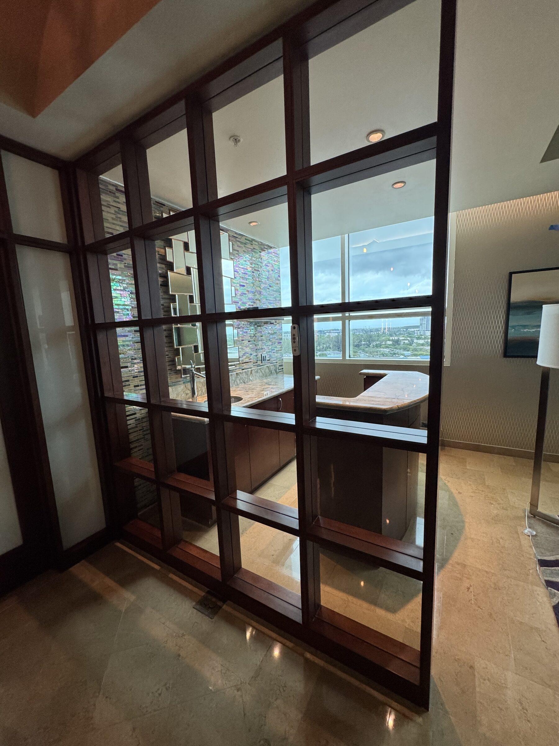 Glass-paneled suite divider with streak-free panes