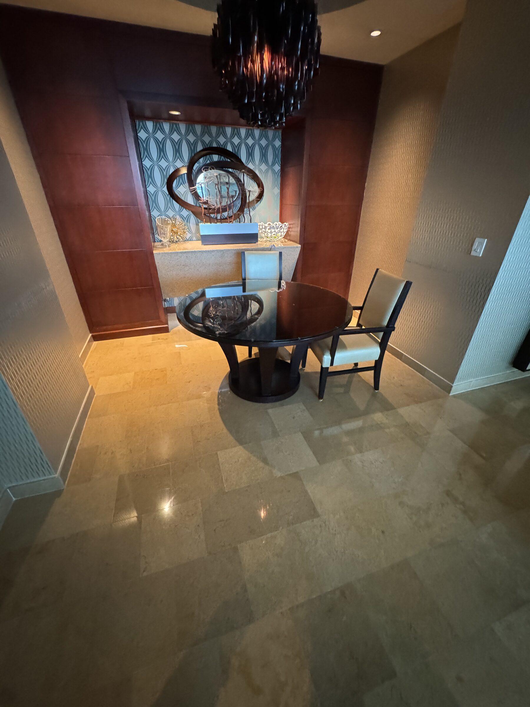 Gleaming dining nook with chandelier and polished tile floors