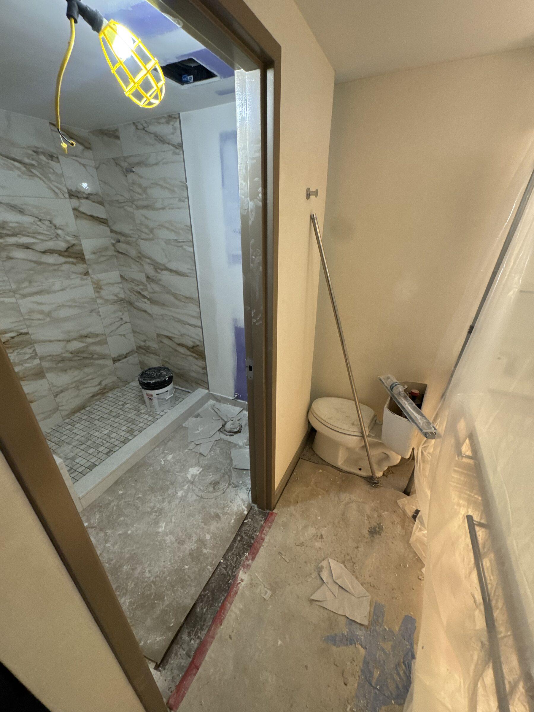 Bathroom renovation in progress, fixtures protected for a phase clean