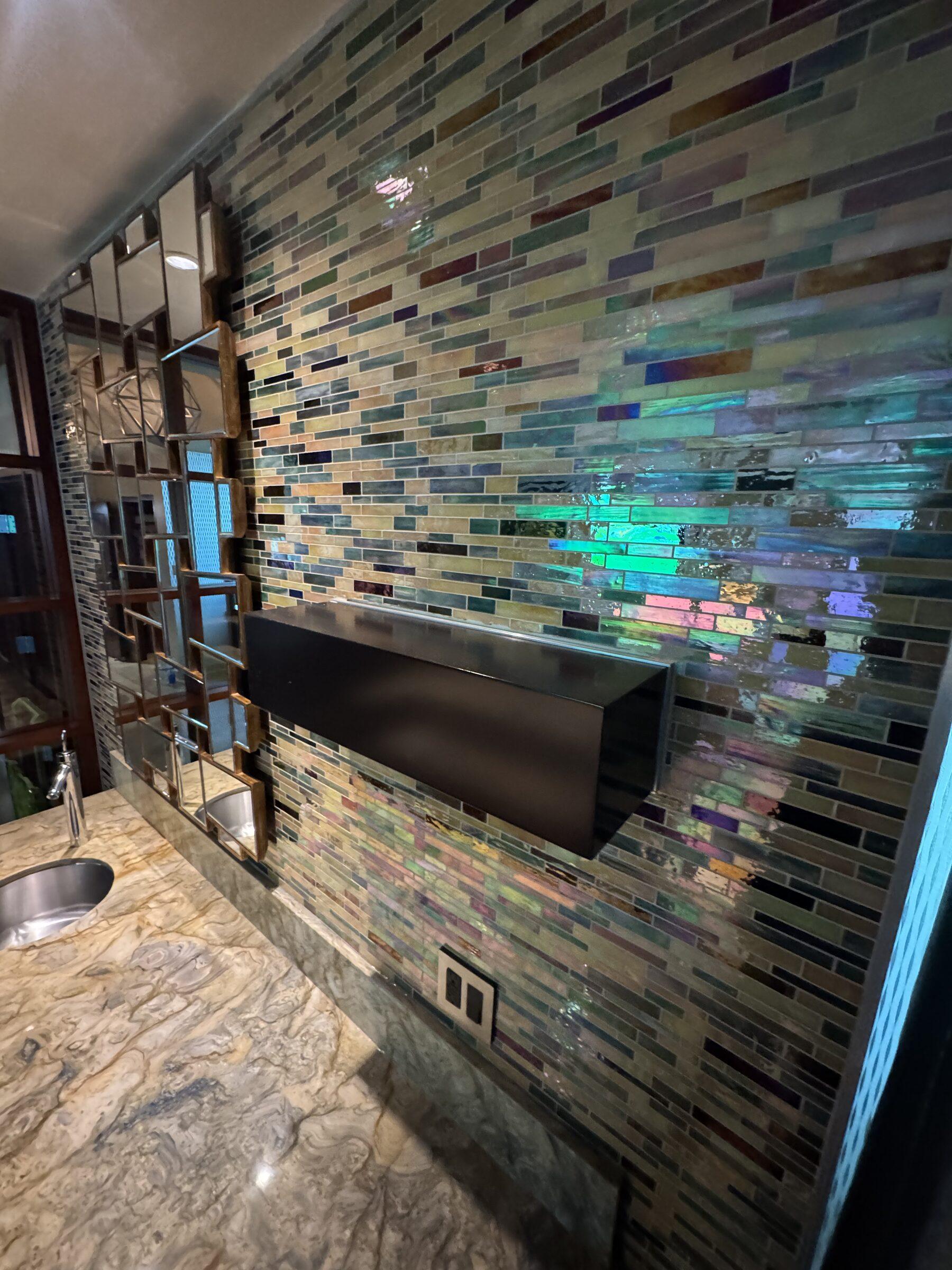 Mosaic tile feature wall and granite vanity after a detail clean